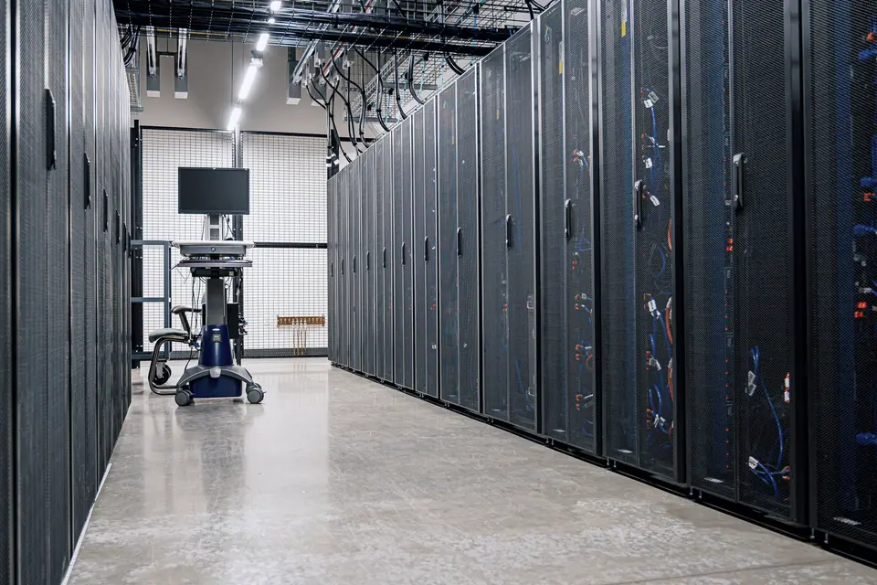 Corridor between rows of server racks in a data center