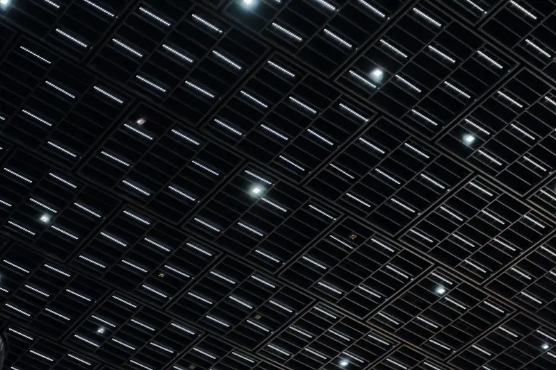 Ceiling with a grid of lights in the dark
