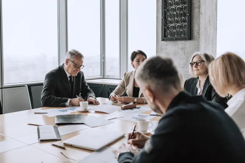 Small team working through documents around a meeting table