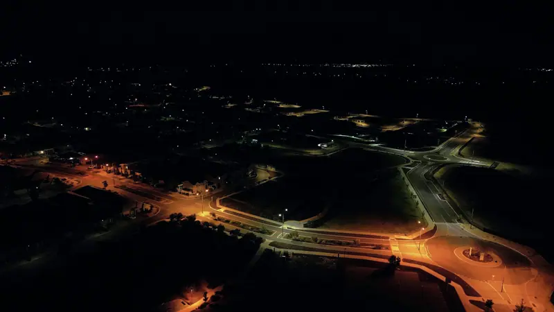 Lit roads and junctions at night, seen from the air